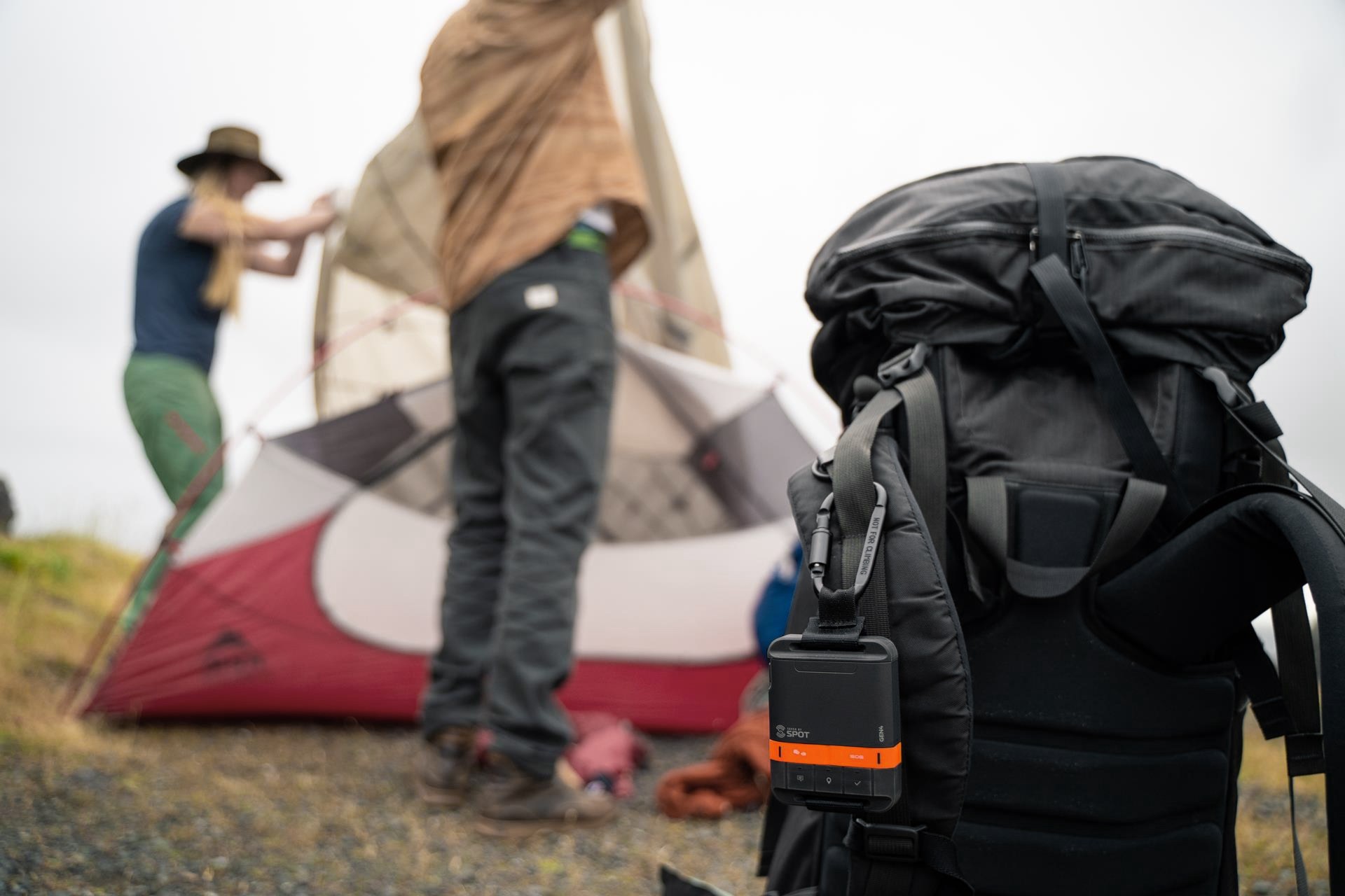 SPOT Gen4 attached to a backpack at a campsite